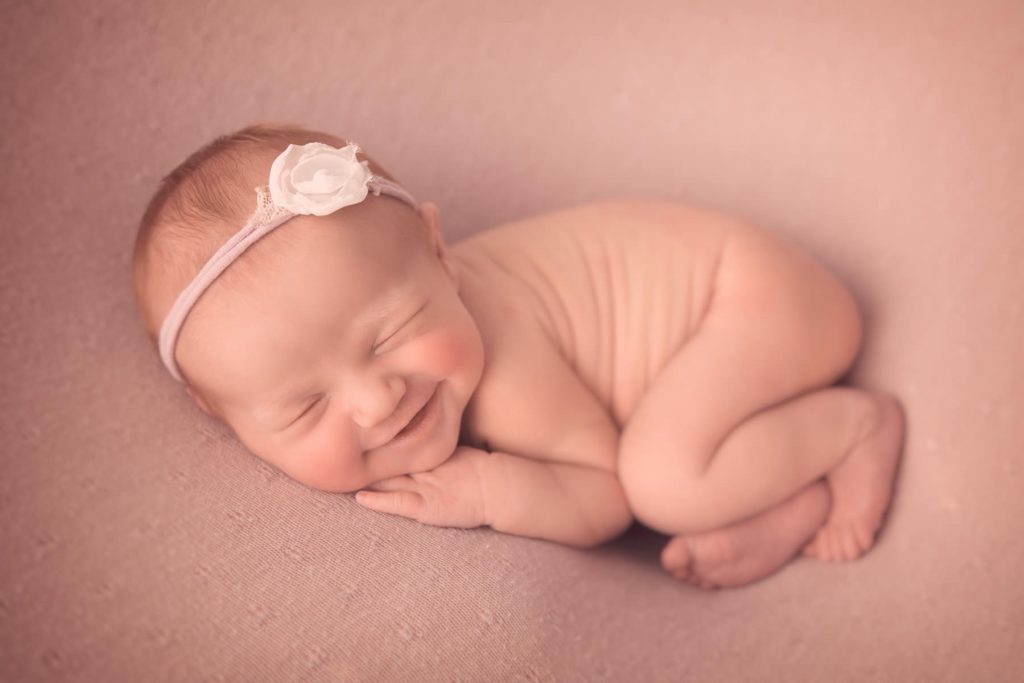 baby girl smiling during Glasgow newborn photo shoot