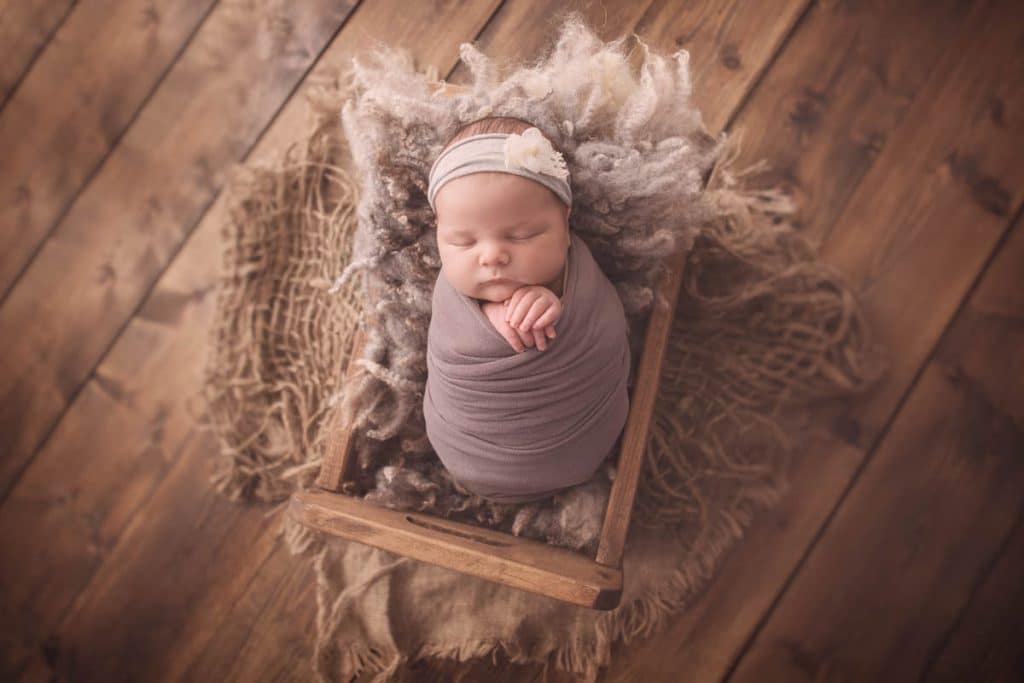 Newborn baby wearing grey headband