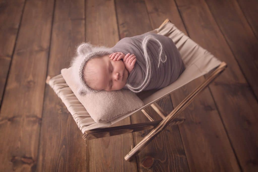 newborn baby girl sleeping in hammock