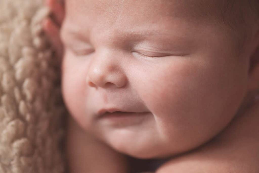 newborn baby girl smiling